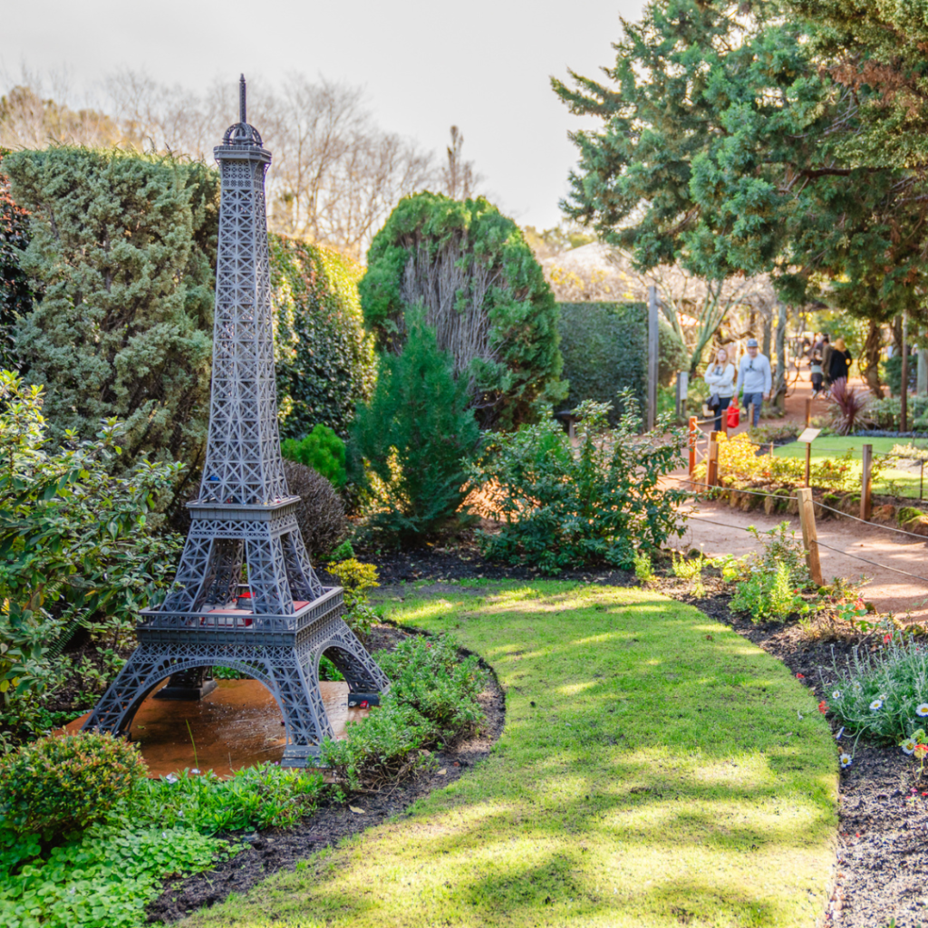 a miniature model of the Eiffel Tower in a garden at Amaze Miniature Park