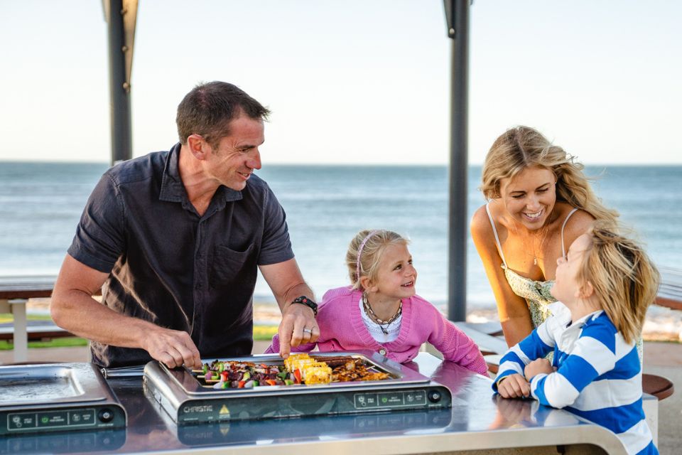 Family cooking a BBQ at Falcon Bay Beach, Mandurah