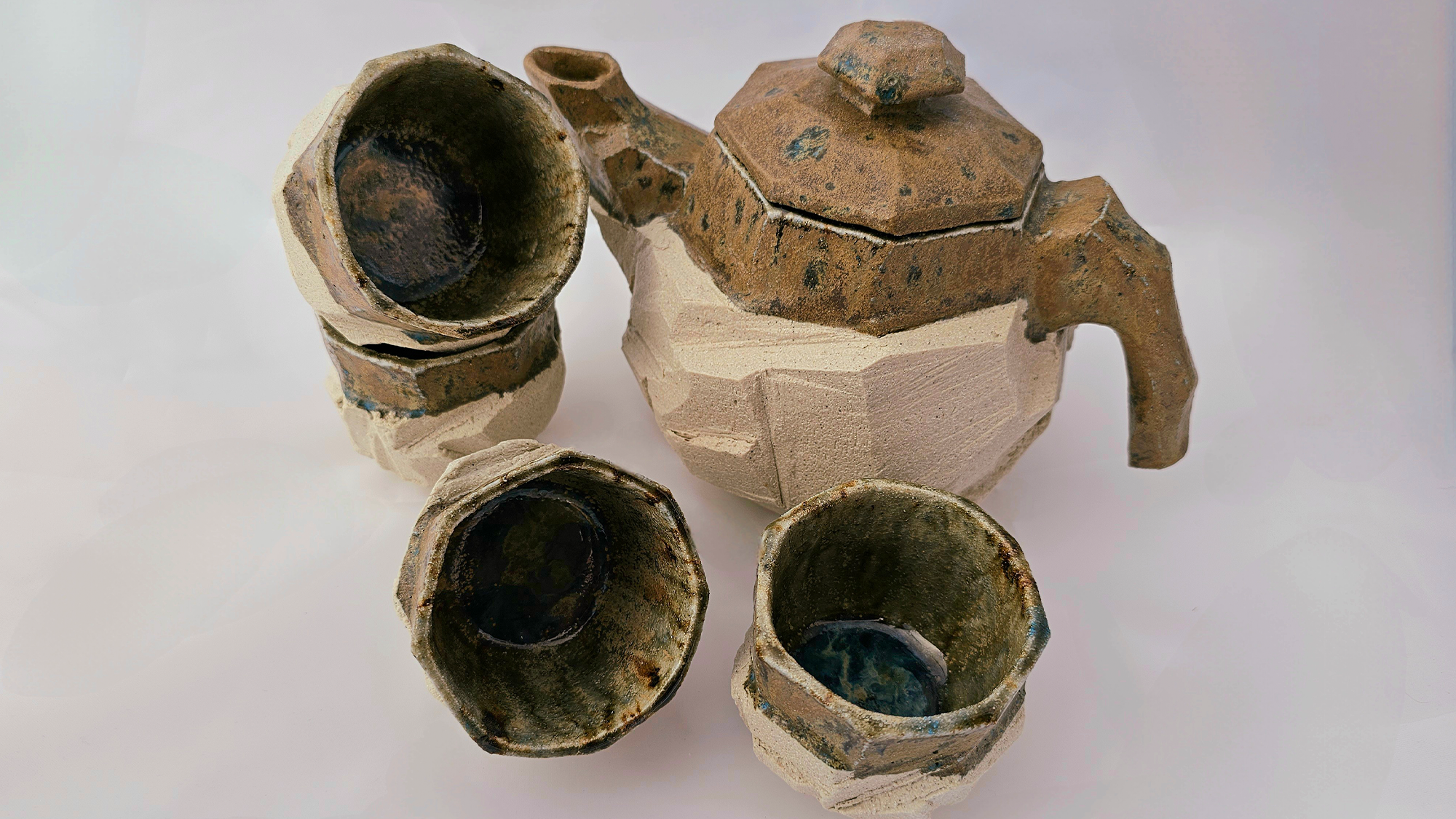 A picture of a ceramic teapot and cups, created by Fox Ward