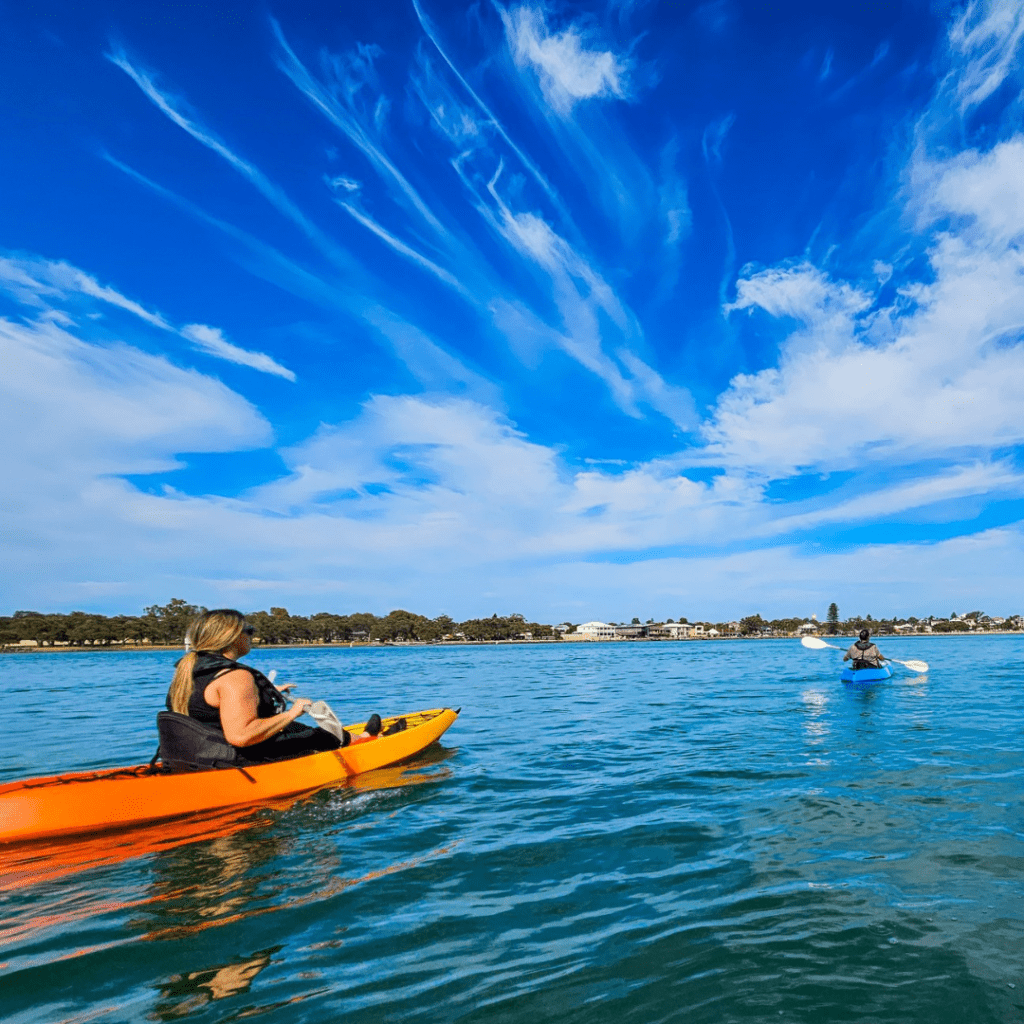 a group of people paddling in kayaks on the water