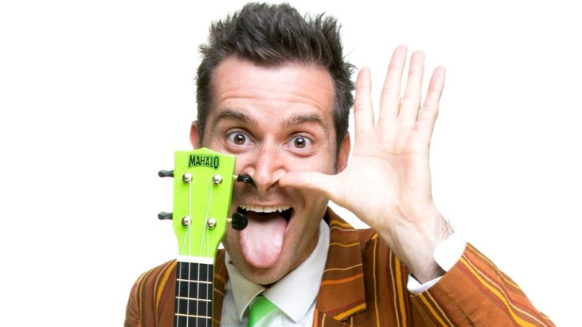 a person in a suit and tie holding a green ukulele