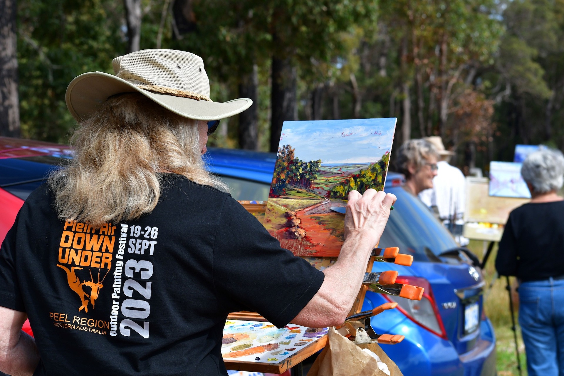 A woman painting an outdoor oil landscape