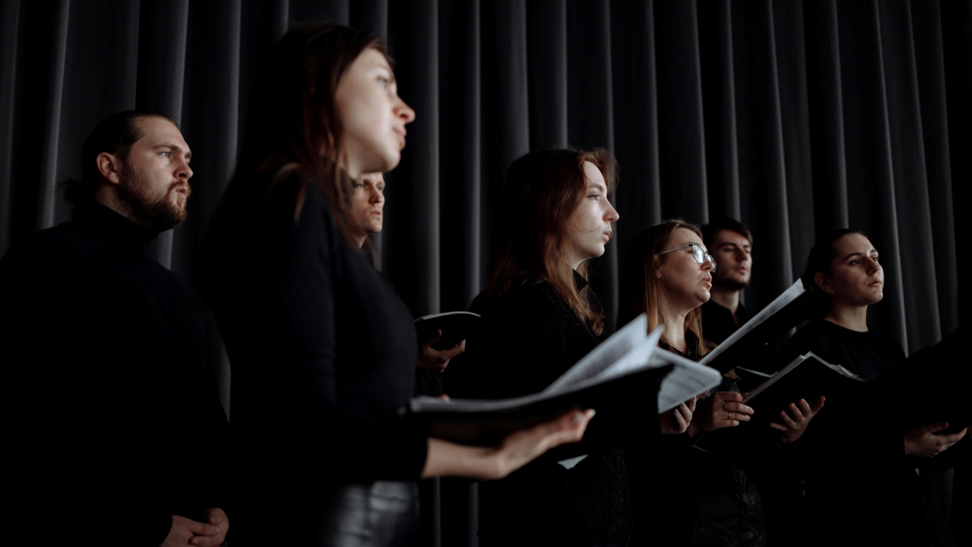 a group of singers dressed in black