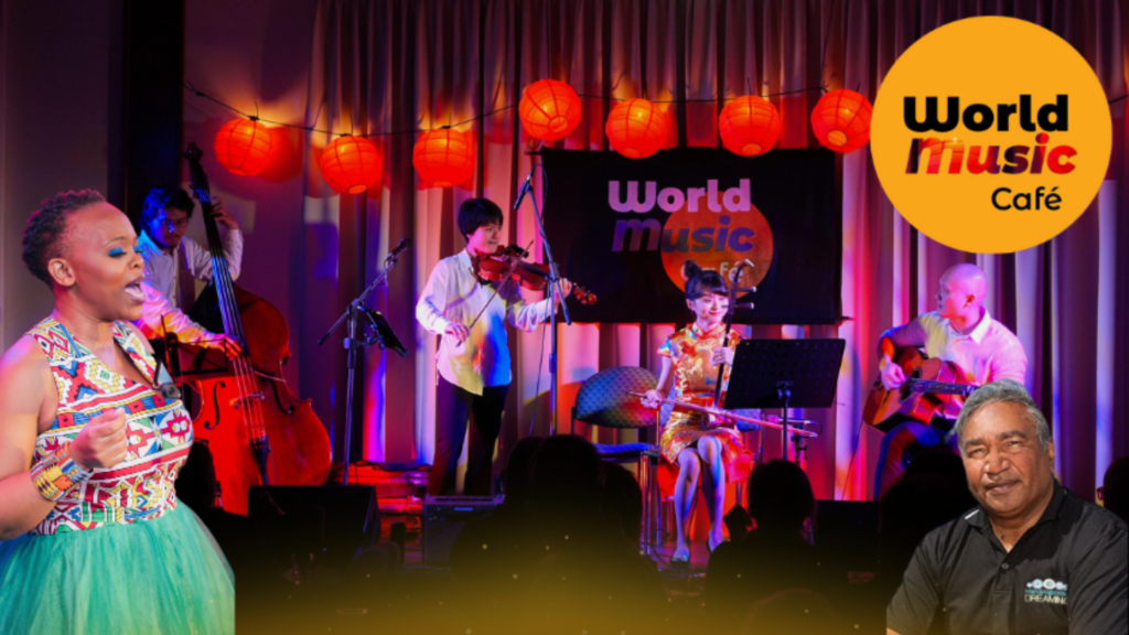 a group of people in front of a stage with the words World Music Gold