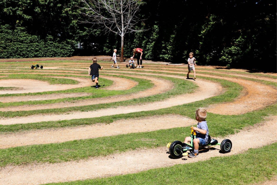 a group of children playing in a circular maze