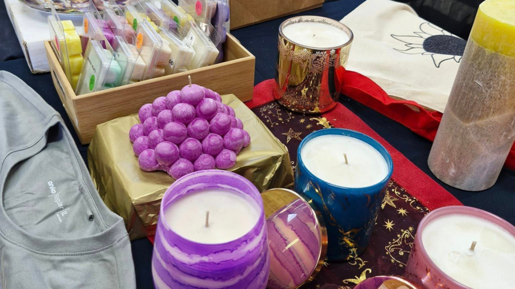 an assortment of candles and other items on a table